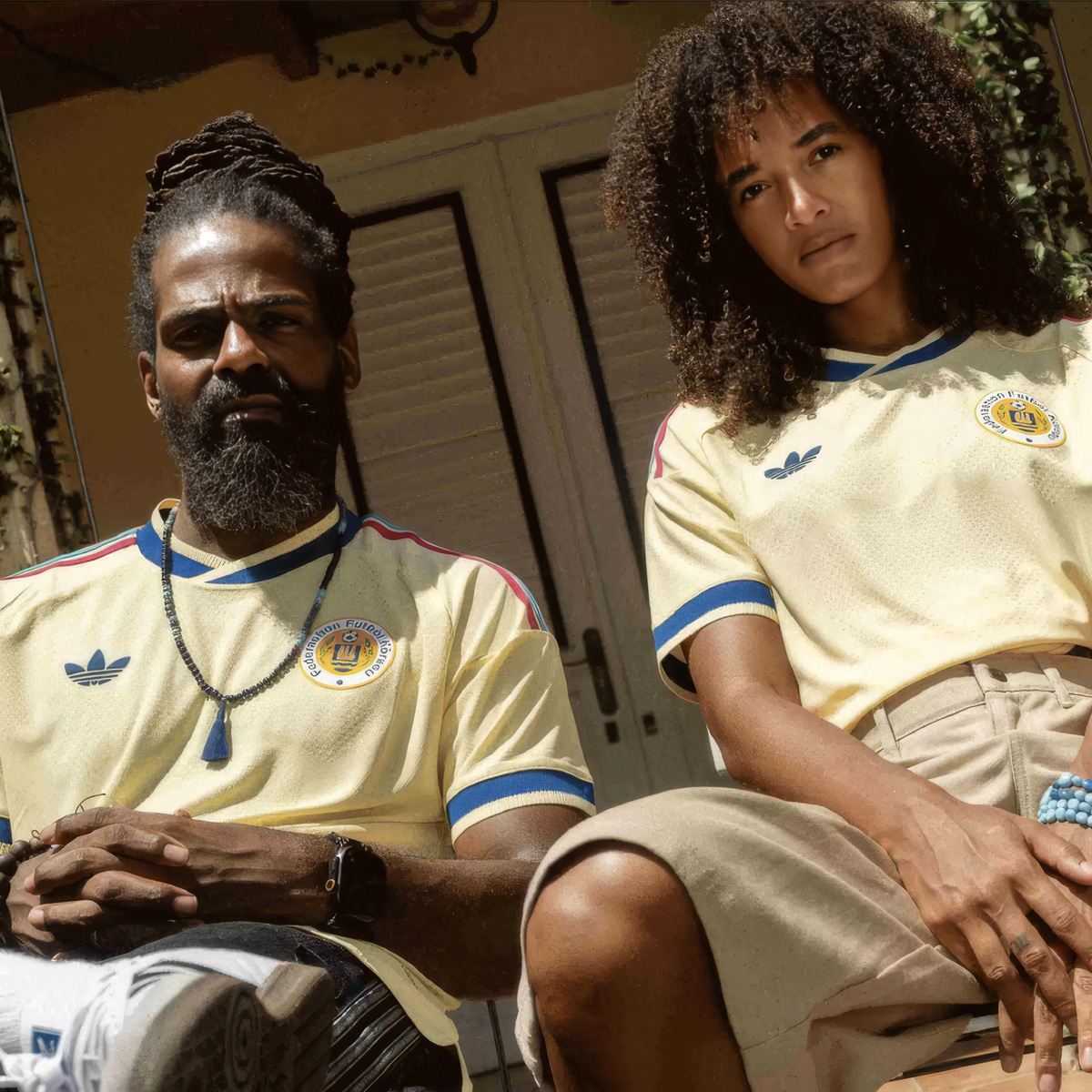 Two people wearing the new Curaçao away kit